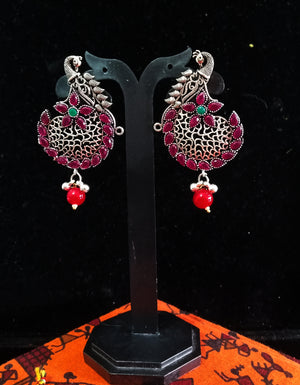 Silver oxidized earrings with pink ruby studded and exclusive silver work for a stunning and stylish look.