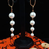 Stand-out dangler with non-precious metal base studded with pearls.