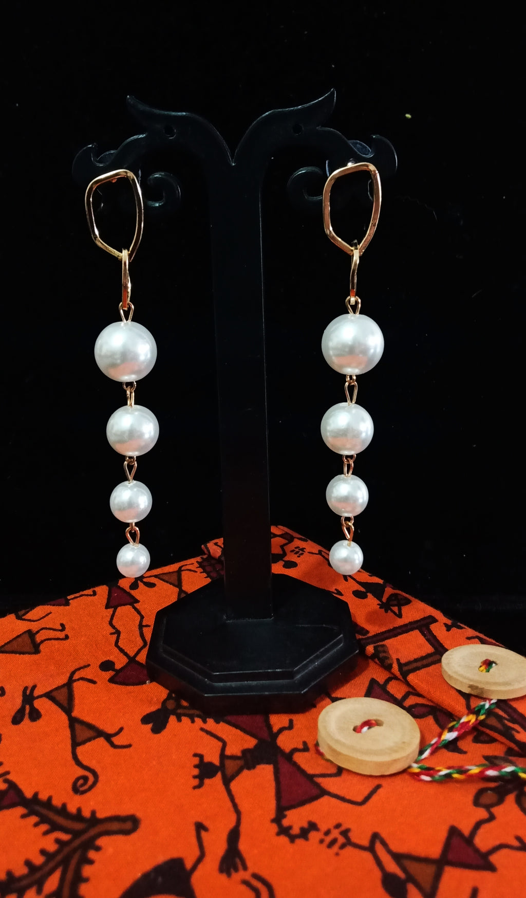 Stand-out dangler with non-precious metal base studded with pearls.