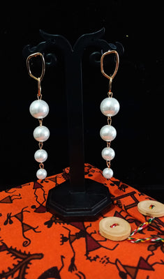 Stand-out dangler with non-precious metal base studded with pearls.