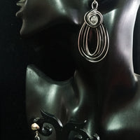Stand-out dangler with non-precious metal base studded with one white crystal.