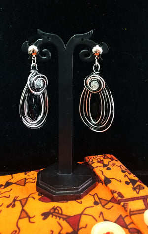 Stand-out dangler with non-precious metal base studded with one white crystal.