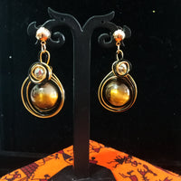 Stand-out dangler with non-precious metal base studded with pearls.