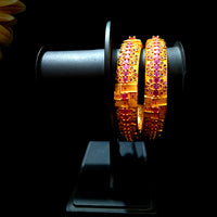 B034_Gorgeous Gold plated bangles matte finish studded with pink ruby stones.
