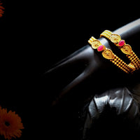 B035_Elegant Gold plated bangle with delicate work studded with pink ruby stones.