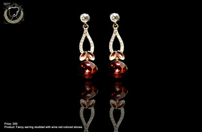 E031_Classy bright golden colored earring with delicate work of wine red colored stone