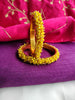 B0273_Lovely golden pearl bangles with delicate craftwork embellished with a bunch of yellow beads.