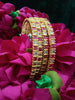B0165_Elegant Golden bangles studded with a touch of pink ruby stones and American Diamond stones.