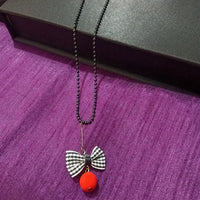 N0279_Trendy bead necklace with bow tie fabric pendant with a touch of beads.