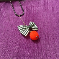 N0279_Trendy bead necklace with bow tie fabric pendant with a touch of beads.