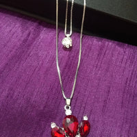 N0281_Classy necklace with crown shaped pendant with sparkling red and white stones.