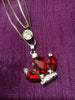 N0281_Classy necklace with crown shaped pendant with sparkling red and white stones.