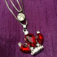 N0281_Classy necklace with crown shaped pendant with sparkling red and white stones.