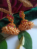 E0836_Gorgeous golden jumkas with peacock design studded with ruby stones with a bunch of bead drops.
