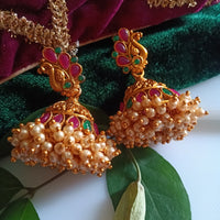 E0836_Gorgeous golden jumkas with peacock design studded with ruby stones with a bunch of bead drops.