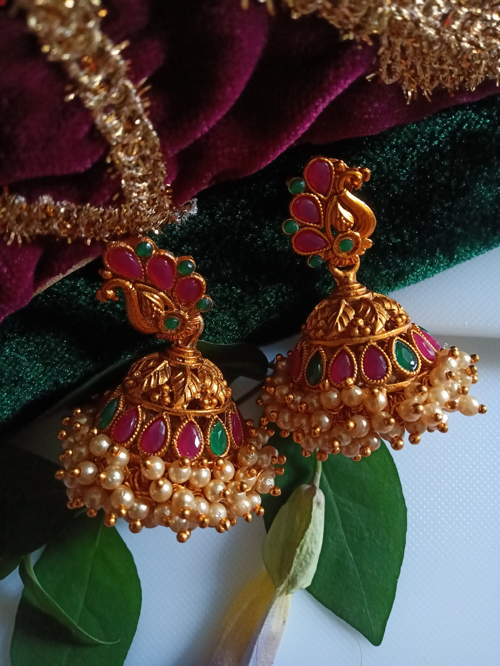 E0836_Gorgeous golden jumkas with peacock design studded with ruby stones with a bunch of bead drops.