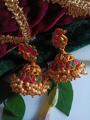 E0836_Gorgeous golden jumkas with peacock design studded with ruby stones with a bunch of bead drops.
