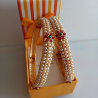 B0212_Classic pearl studded bangles with delicate flower design with a touch of pink & green ruby stones.