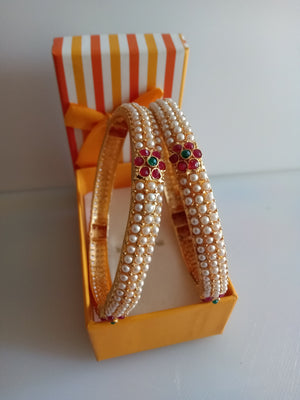 B0212_Classic pearl studded bangles with delicate flower design with a touch of pink & green ruby stones.