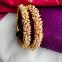 B0222_Lovely golden pearl bangles with delicate craftwork embellished with a bunch of pearls.