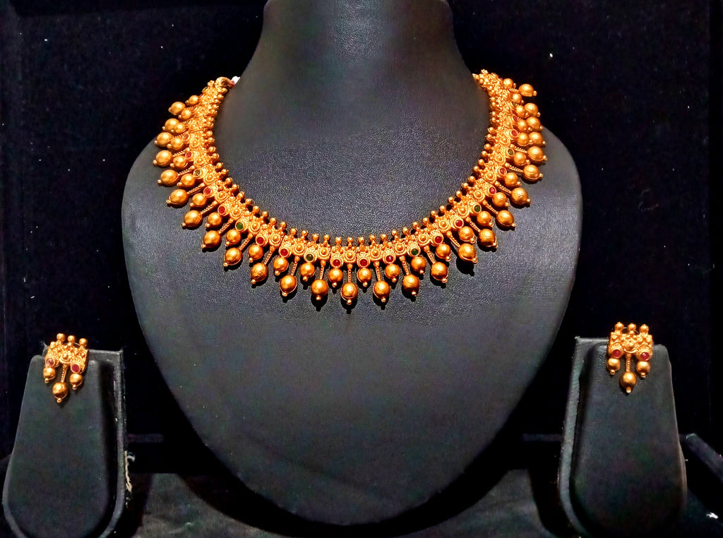 Pleasing and graceful necklaces laden with exquisite work of Temple jewelry structure and ruby stones