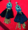 Stand-out dangler with non-precious metal base studded with trendy silk threads