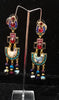 Stand-out dangler with non-precious metal base studded with trendy silk threads
