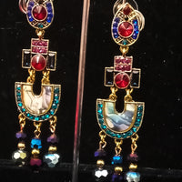 Stand-out dangler with non-precious metal base studded with trendy silk threads