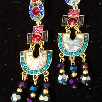 Stand-out dangler with non-precious metal base studded with trendy silk threads
