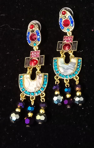 Stand-out dangler with non-precious metal base studded with trendy silk threads