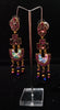 Stand-out dangler with non-precious metal base studded with trendy silk threads