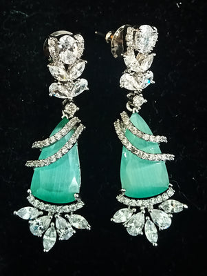 Sparkling Silver based earring with careful stitching of American Diamond