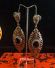 Stand-out dangler with non-precious metal base studded with trendy stones