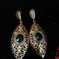 Stand-out dangler with non-precious metal base studded with trendy stones