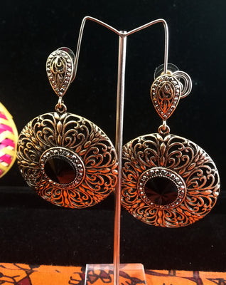 Stand-out dangler with non-precious metal base studded with trendy stones
