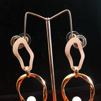 Stand-out dangler with non-precious metal base studded with trendy stones