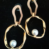 Stand-out dangler with non-precious metal base studded with trendy stones