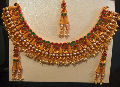Pleasing and graceful necklaces laden with exquisite work of Temple jewelry structure and ruby stones