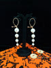 Stand-out dangler with non-precious metal base studded with pearls.