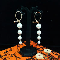 Stand-out dangler with non-precious metal base studded with pearls.