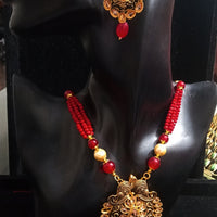 Pleasing and graceful Jaipur necklace laden with exquisite work of red & off white pearls and red crystal