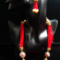 Pleasing and graceful necklace laden with exquisite work of red crystals, beautiful pearls and kundan