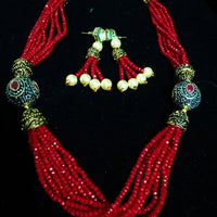 Pleasing and graceful necklace laden with exquisite work of red crystals, beautiful pearls and kundan