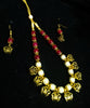Pleasing and graceful Jaipur necklace laden with exquisite work of red & off white pearls .