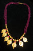 Pleasing and graceful gold plate-ted necklace laden with exquisite work of berry/wine purple colored crystals