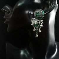 Silver oxidized earrings with green ruby studded and exclusive silver work for a stunning and stylish look.
