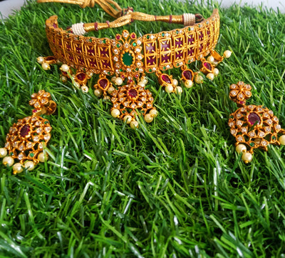 N0105_Elegant Temple jewelry style matte gold polish necklace set studded with American Diamond  stones with a touch of pink & green ruby stones.