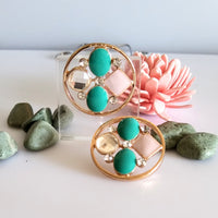 E0414_Classy circular shaped stud with a touch of ocean green & pale pink stones.