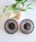 E0409_Classy stud studded with stones & black base metal wheel design earring.