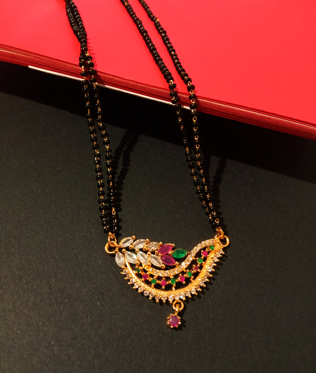 N0184_Elegant style mangalsutra with beautiful leafy design pendant studded with American Diamond stones with a touch of pink and green ruby stones.